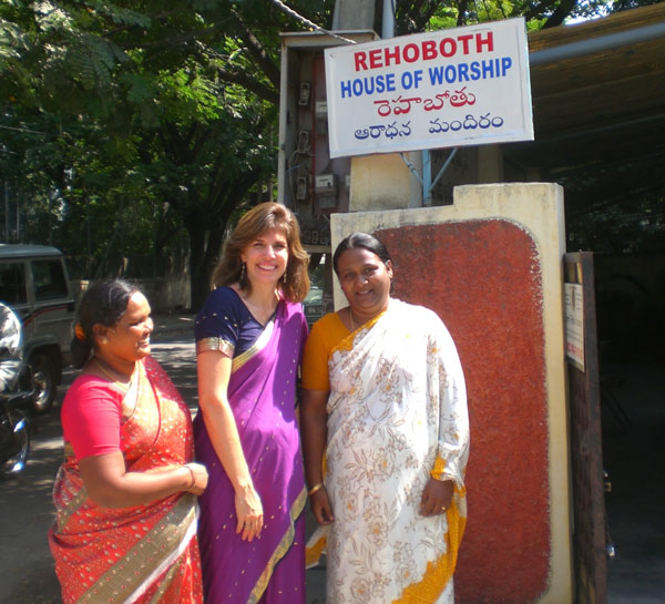 Susan with Shanthi in front of Rehoboth church (center and right) during 2009 conference.