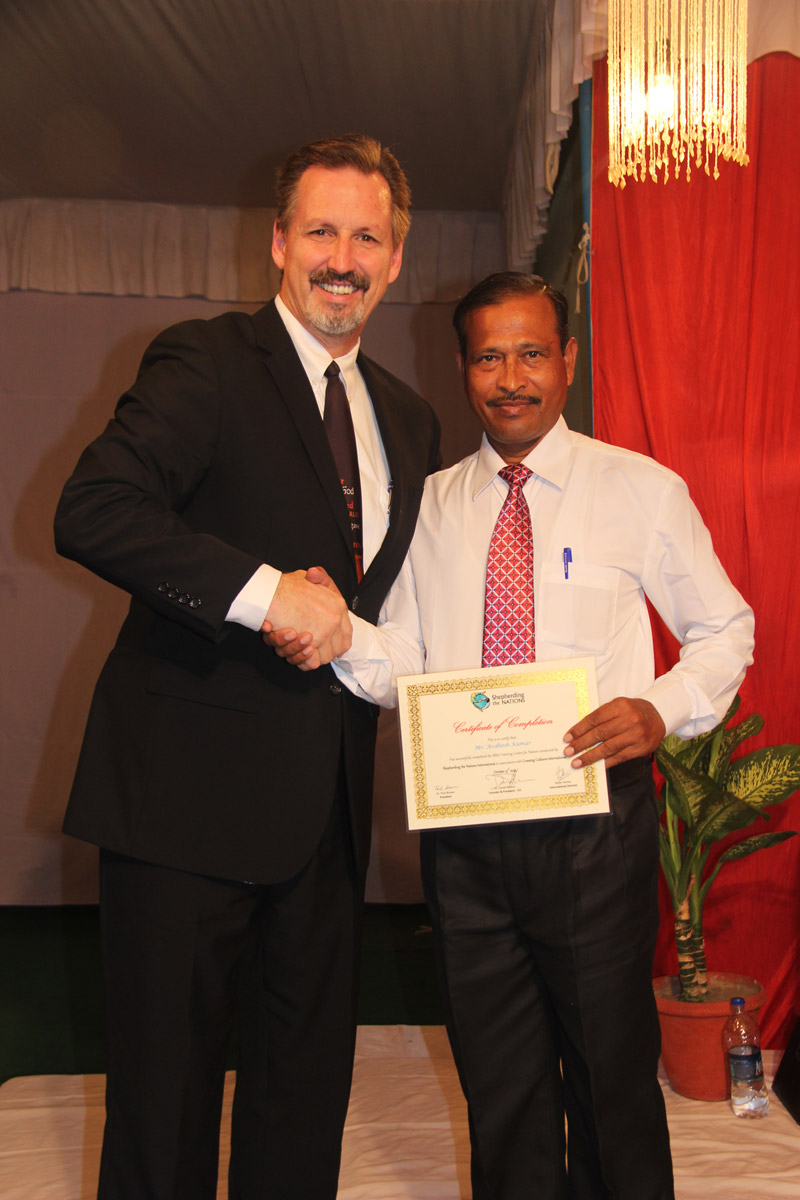 Pastor A.K. receives his graduation certificate in October 2014